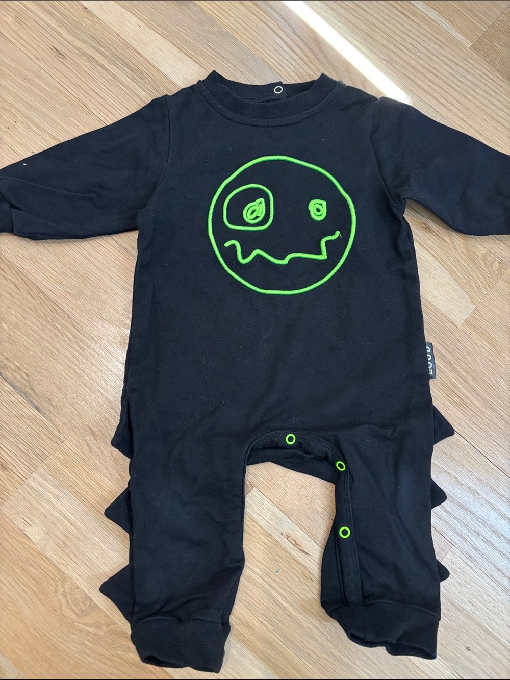 Loud Apparel Black Baby One-Piece Footie with Neon Green Smiley